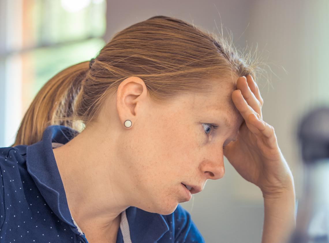 woman with headache while reading